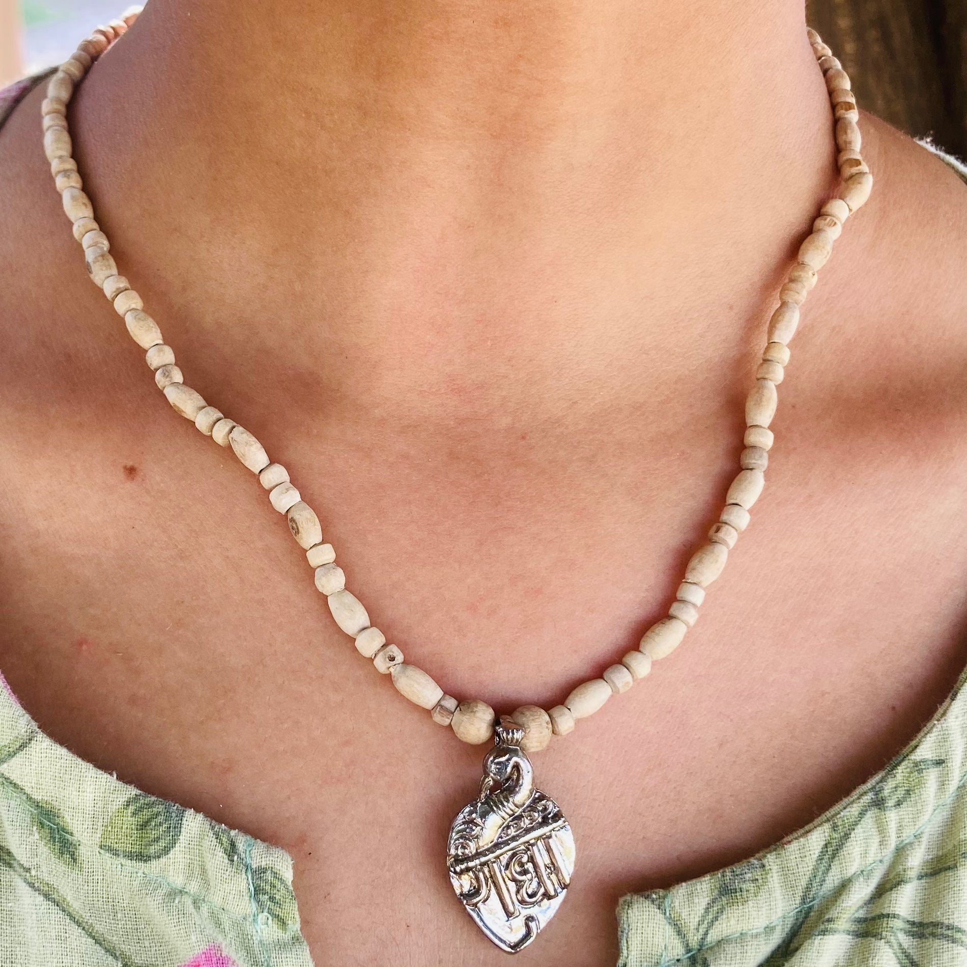 Handcrafted Radha Naam Tulsi Mala with pure Tulsi wood beads and Radha Naam engraved locket, offering spiritual protection, devotion, and blessings from Vrindavan.
