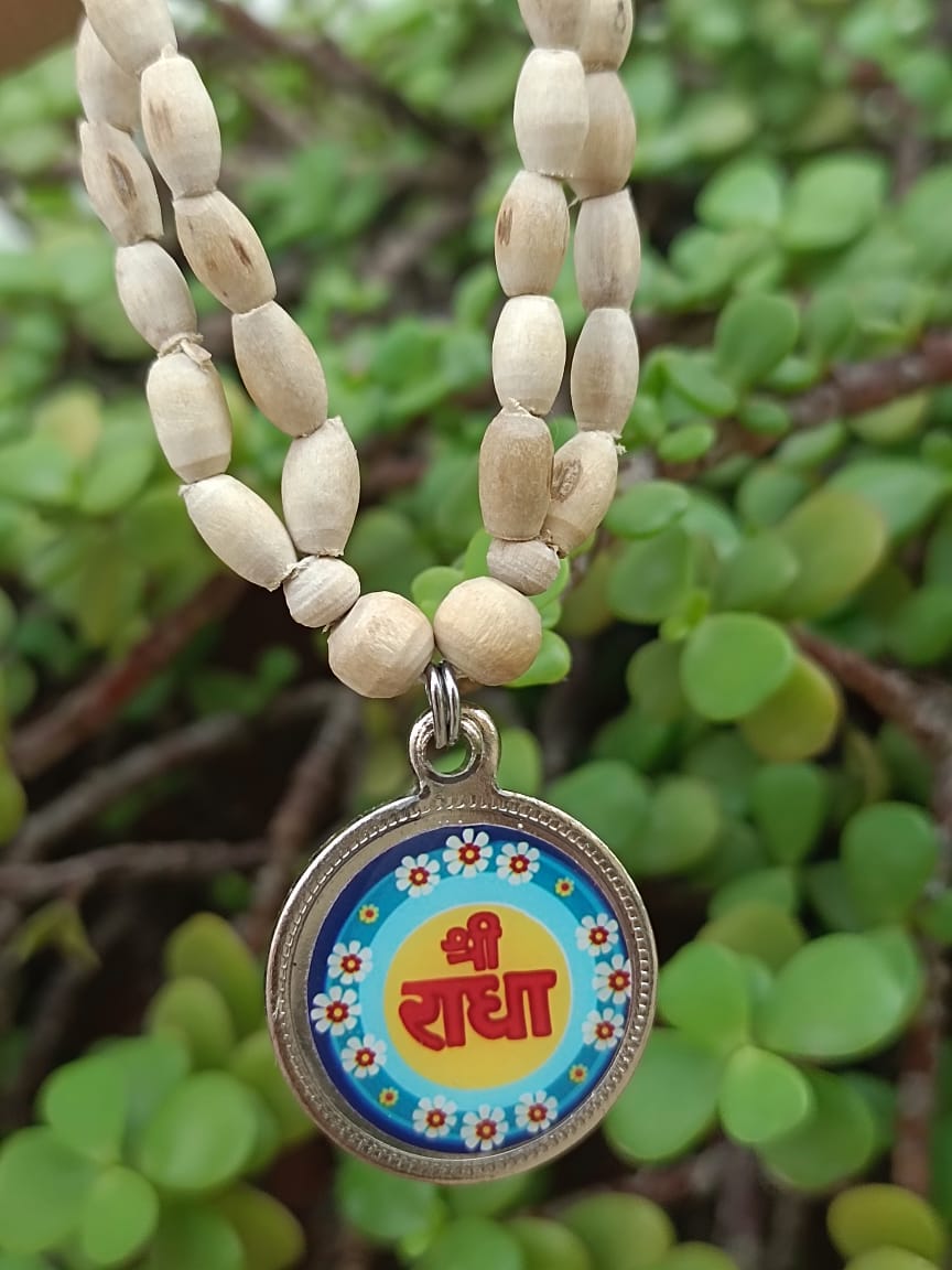Radha Naam Tulsi Mala with pure Tulsi wood beads and Radha Naam engraved locket, handcrafted in Vrindavan for spiritual protection and devotion.

