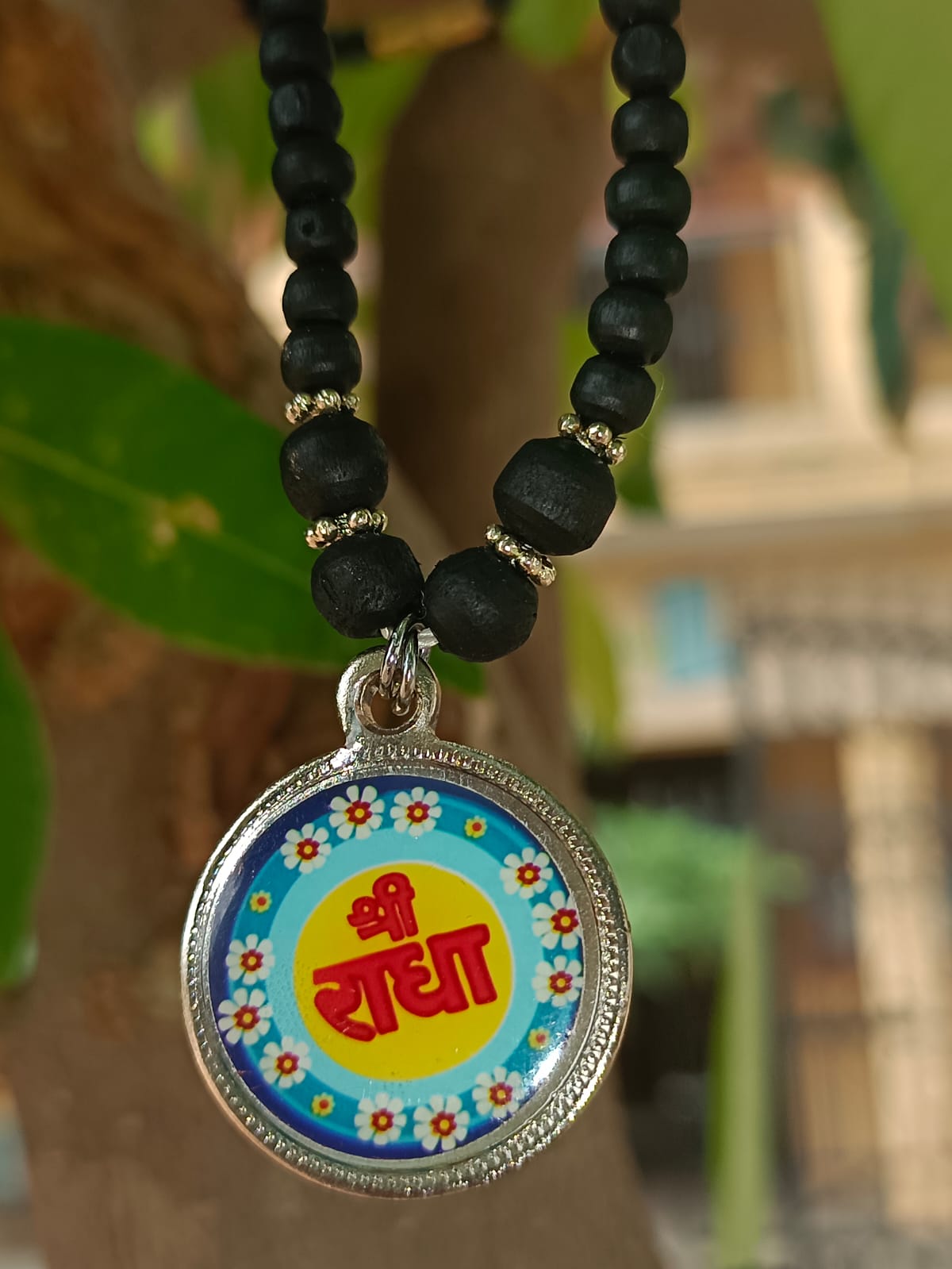 Radha Naam Tulsi Mala made from pure Tulsi wood, engraved with Radha's name, offering spiritual protection and devotion, handcrafted in Vrindavan.