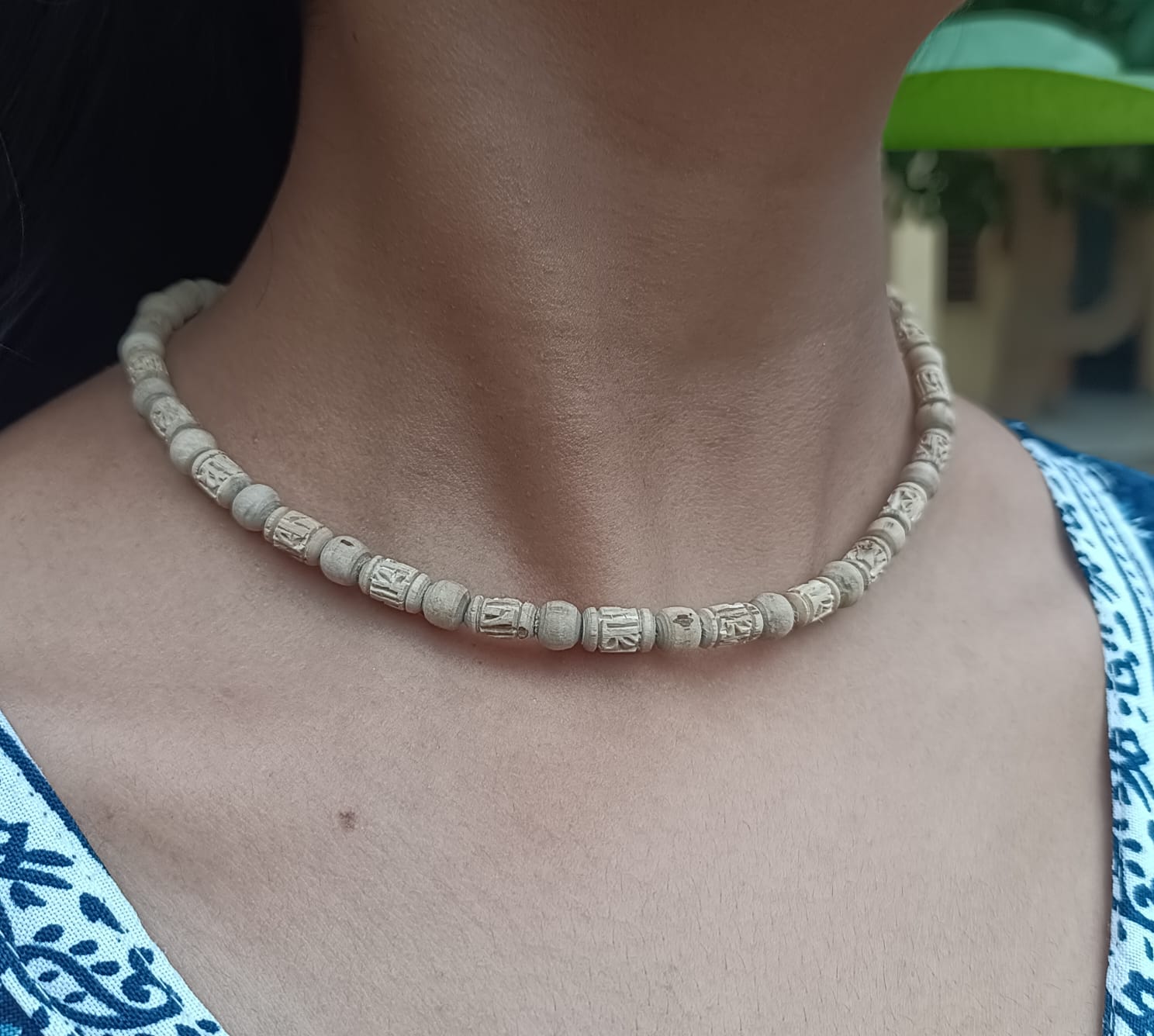 Radha Naam Tulsi Mala made from pure Tulsi wood with Radha's name engraved on each bead, handcrafted in Vrindavan for spiritual protection and devotion.